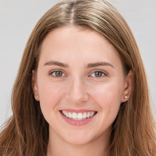 Joyful white young-adult female with long  brown hair and grey eyes