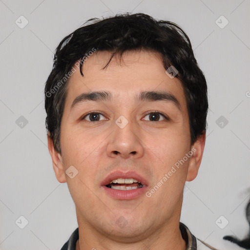 Joyful white young-adult male with short  black hair and brown eyes