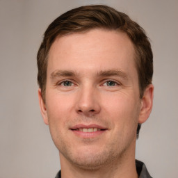 Joyful white young-adult male with short  brown hair and grey eyes