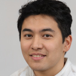 Joyful latino young-adult male with short  brown hair and brown eyes