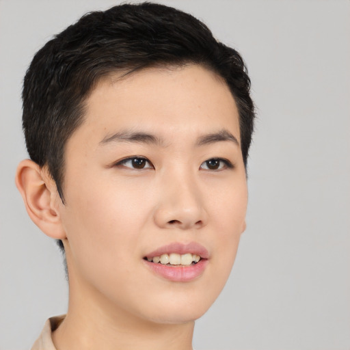 Joyful asian young-adult male with short  black hair and brown eyes