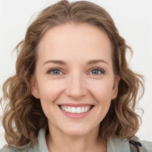 Joyful white young-adult female with medium  brown hair and blue eyes