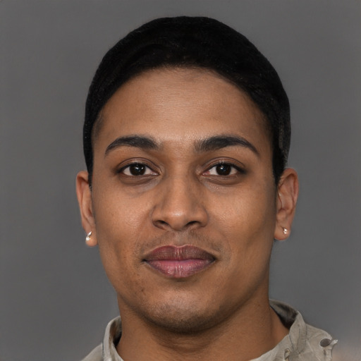 Joyful black young-adult male with short  black hair and brown eyes