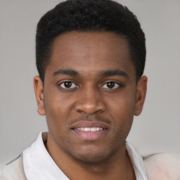 Joyful black young-adult male with short  black hair and brown eyes