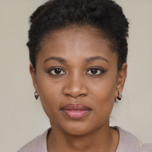Joyful black young-adult female with short  black hair and brown eyes