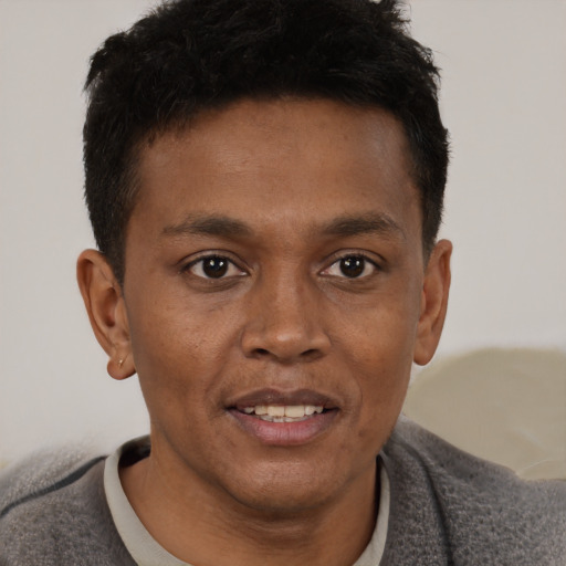 Joyful black young-adult male with short  brown hair and brown eyes