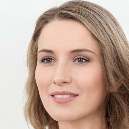 Joyful white young-adult female with long  brown hair and green eyes