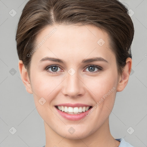 Joyful white young-adult female with short  brown hair and grey eyes