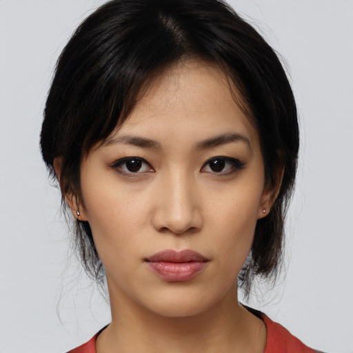Joyful asian young-adult female with medium  brown hair and brown eyes