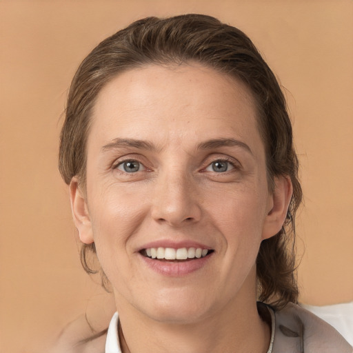 Joyful white adult female with medium  brown hair and brown eyes