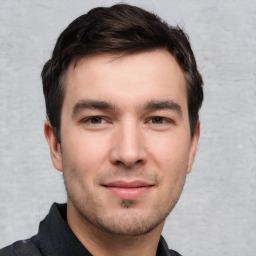 Joyful white young-adult male with short  brown hair and brown eyes