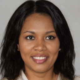 Joyful black young-adult female with medium  brown hair and brown eyes