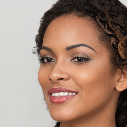 Joyful latino young-adult female with long  brown hair and brown eyes