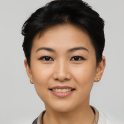 Joyful asian young-adult female with short  black hair and brown eyes