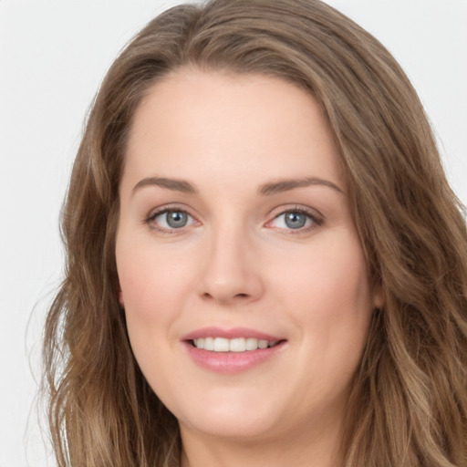 Joyful white young-adult female with long  brown hair and green eyes