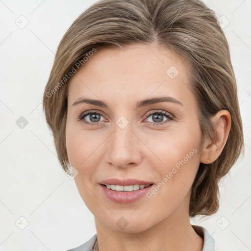 Joyful white young-adult female with medium  brown hair and grey eyes