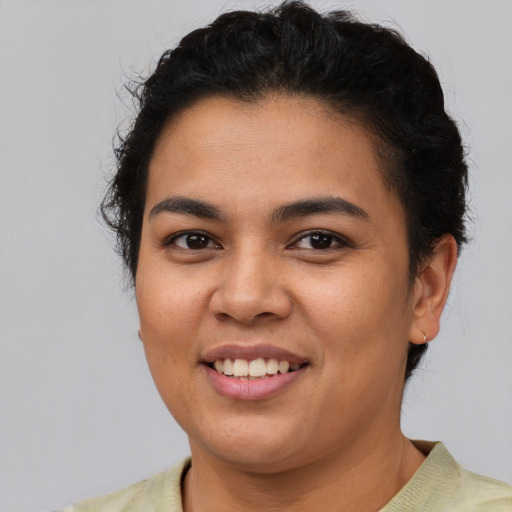 Joyful latino young-adult female with short  brown hair and brown eyes