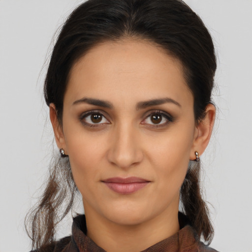 Joyful latino young-adult female with medium  brown hair and brown eyes