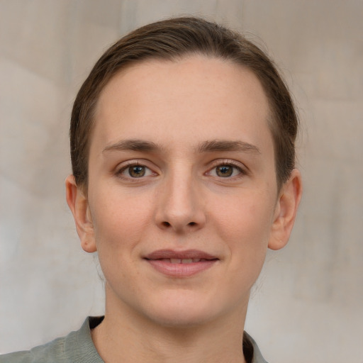 Joyful white young-adult female with medium  brown hair and grey eyes