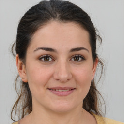 Joyful white young-adult female with medium  brown hair and brown eyes