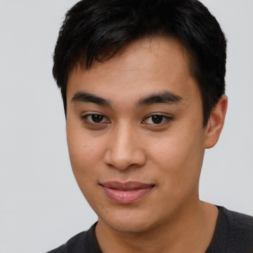 Joyful asian young-adult male with short  brown hair and brown eyes