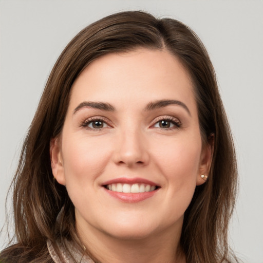 Joyful white young-adult female with long  brown hair and brown eyes