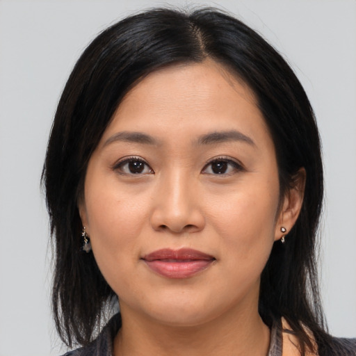 Joyful asian young-adult female with medium  brown hair and brown eyes