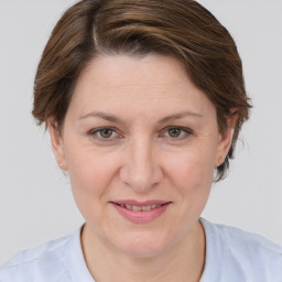 Joyful white adult female with medium  brown hair and grey eyes