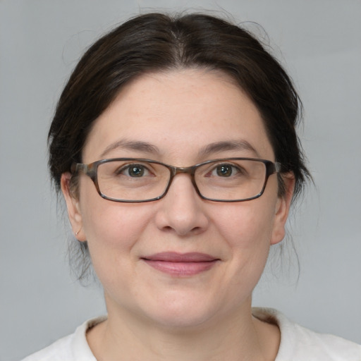 Joyful white adult female with medium  brown hair and brown eyes