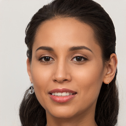 Joyful white young-adult female with long  brown hair and brown eyes