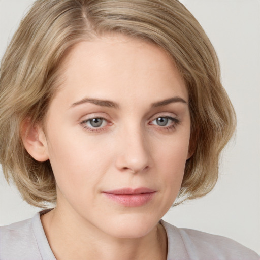 Joyful white young-adult female with medium  brown hair and blue eyes