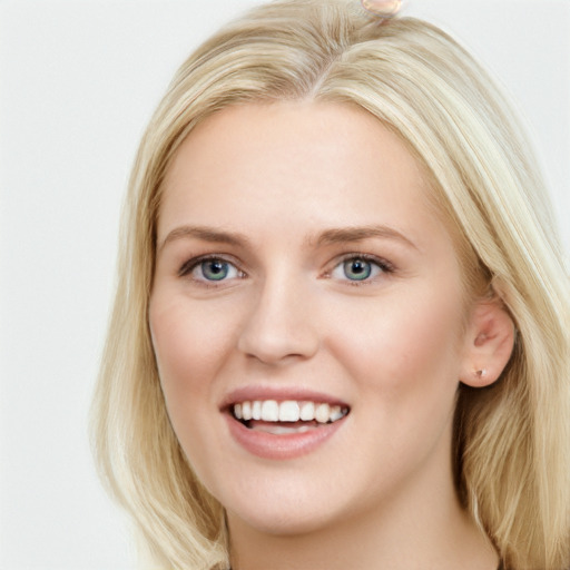 Joyful white young-adult female with long  brown hair and blue eyes