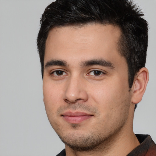 Joyful white young-adult male with short  black hair and brown eyes