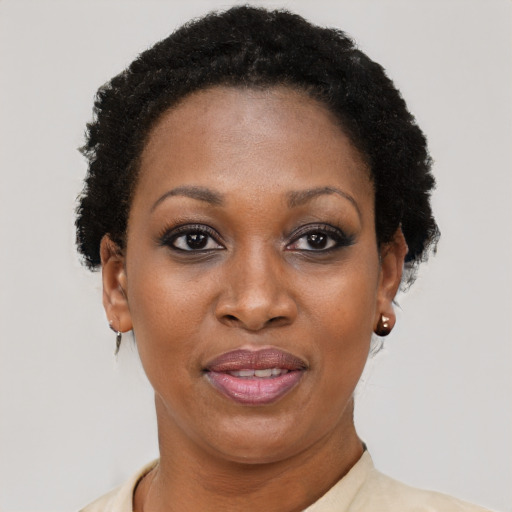 Joyful black adult female with short  black hair and brown eyes
