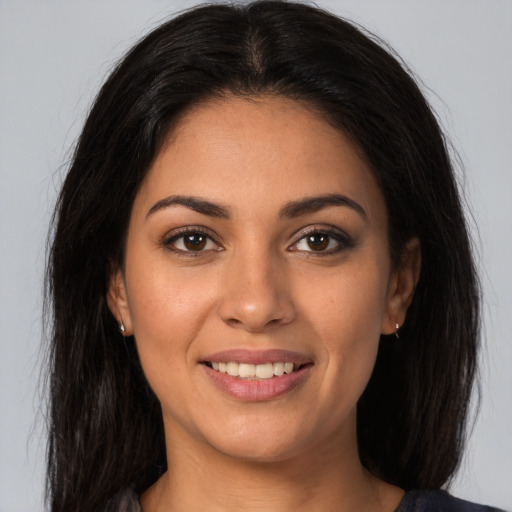 Joyful latino young-adult female with long  brown hair and brown eyes