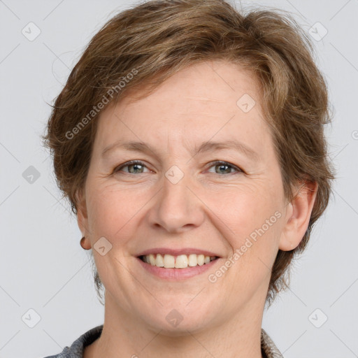 Joyful white adult female with medium  brown hair and grey eyes