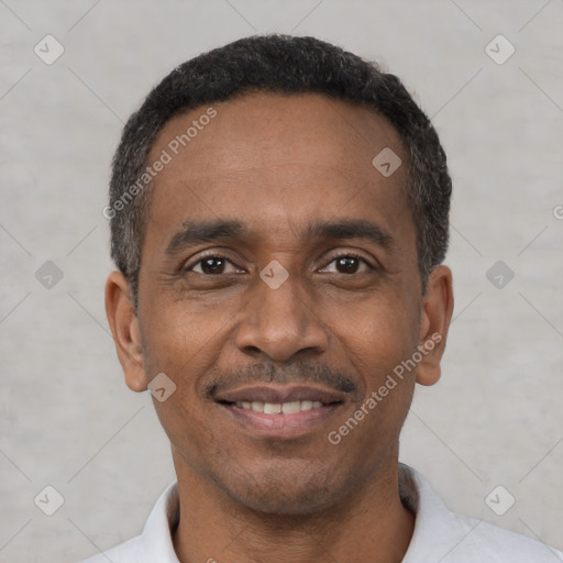 Joyful black adult male with short  black hair and brown eyes