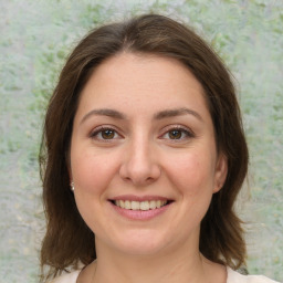 Joyful white young-adult female with medium  brown hair and green eyes