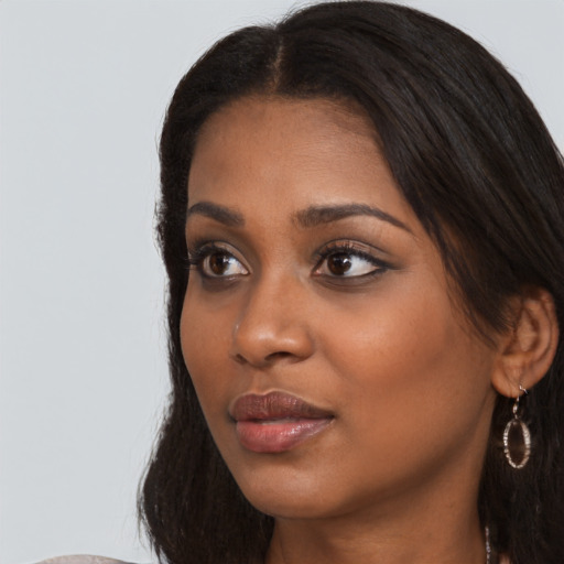 Neutral black young-adult female with long  brown hair and brown eyes