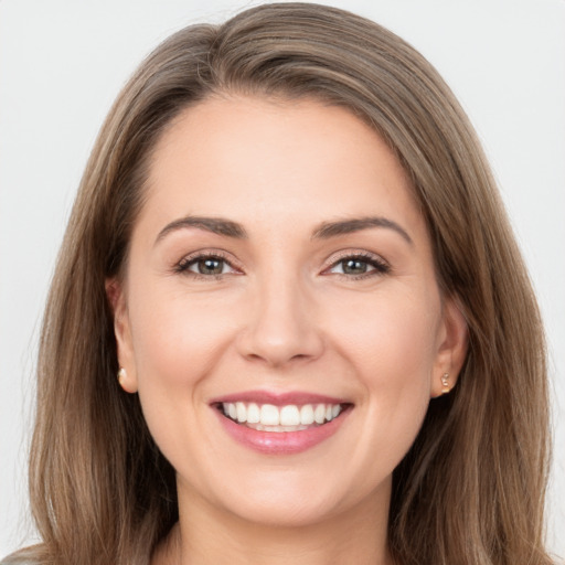 Joyful white young-adult female with long  brown hair and grey eyes