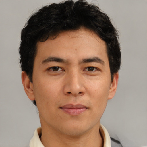 Joyful asian adult male with short  brown hair and brown eyes