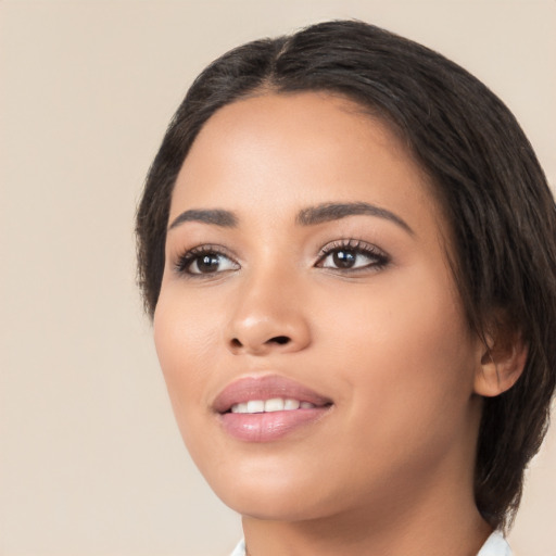 Joyful latino young-adult female with medium  black hair and brown eyes