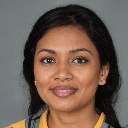 Joyful black young-adult female with medium  black hair and brown eyes