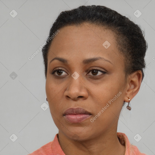 Joyful black adult female with short  brown hair and brown eyes