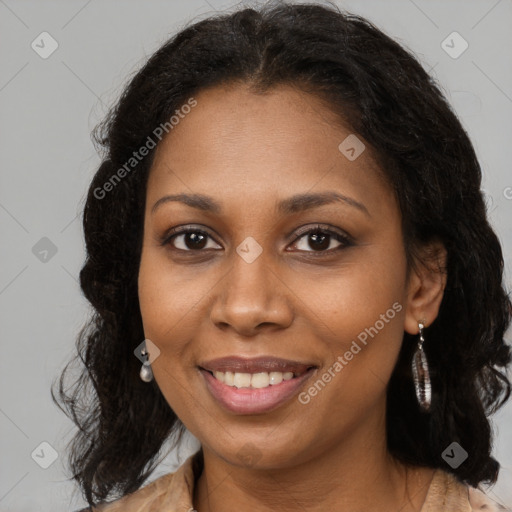 Joyful black adult female with long  brown hair and brown eyes