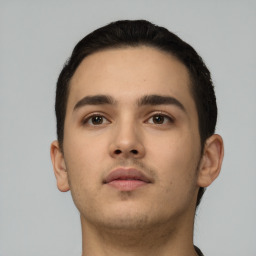 Neutral latino young-adult male with short  brown hair and brown eyes
