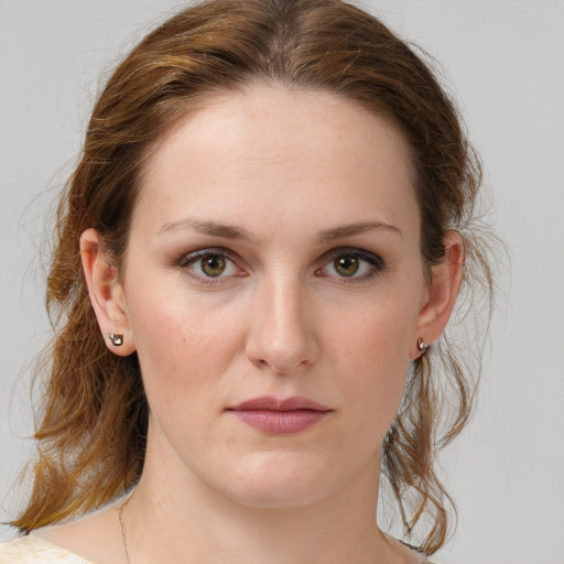 Joyful white young-adult female with medium  brown hair and green eyes