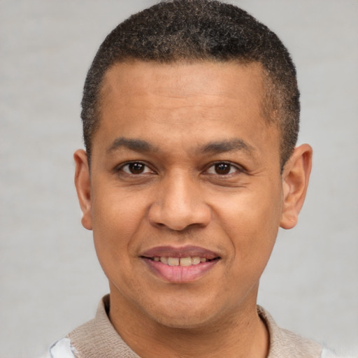 Joyful latino adult male with short  brown hair and brown eyes