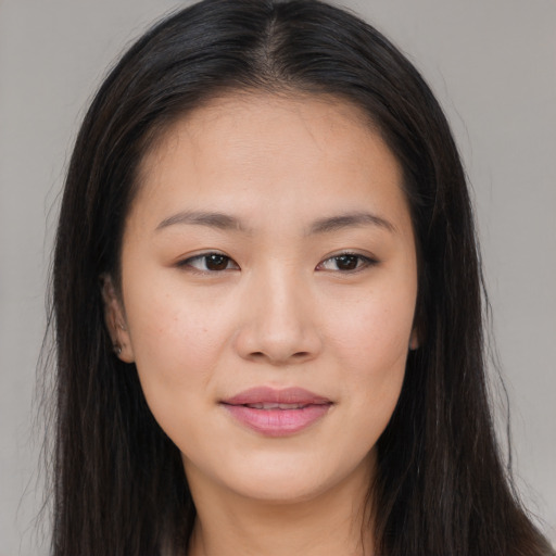 Joyful asian young-adult female with long  brown hair and brown eyes