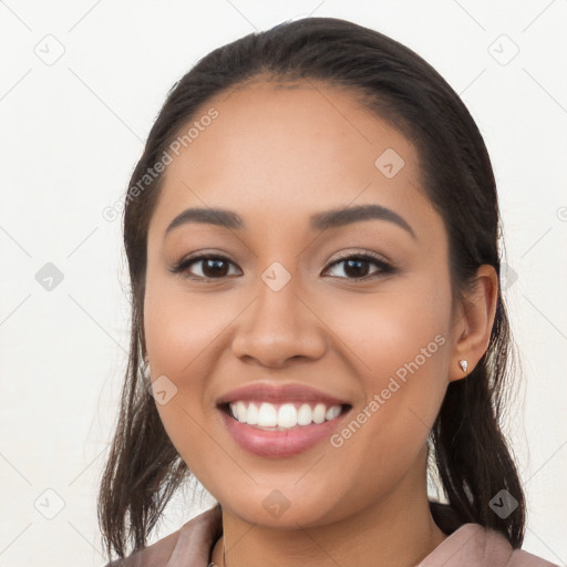 Joyful latino young-adult female with long  brown hair and brown eyes